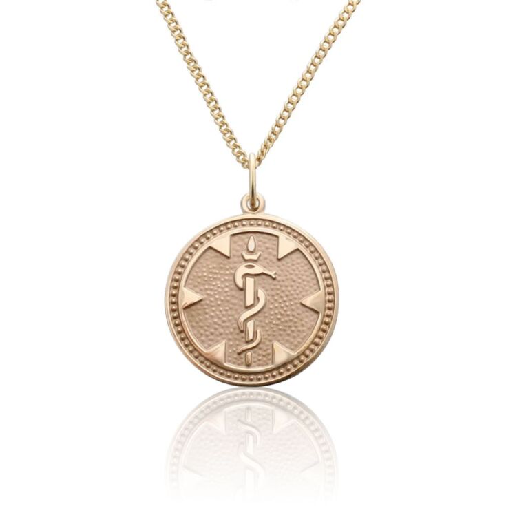 round medallion medical id gold pendant with embossed detail of medical emblem