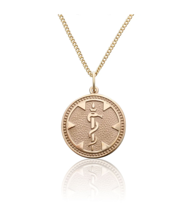 round medallion medical id gold pendant with embossed detail of medical emblem